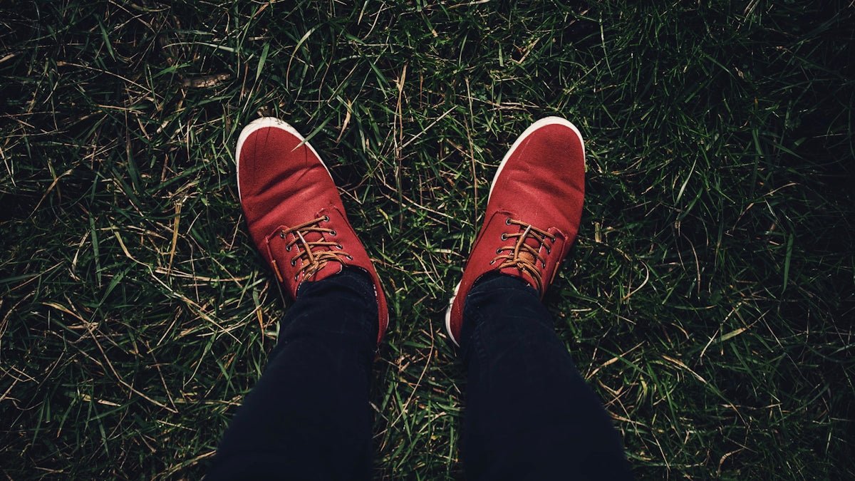 person in red nike sneakers