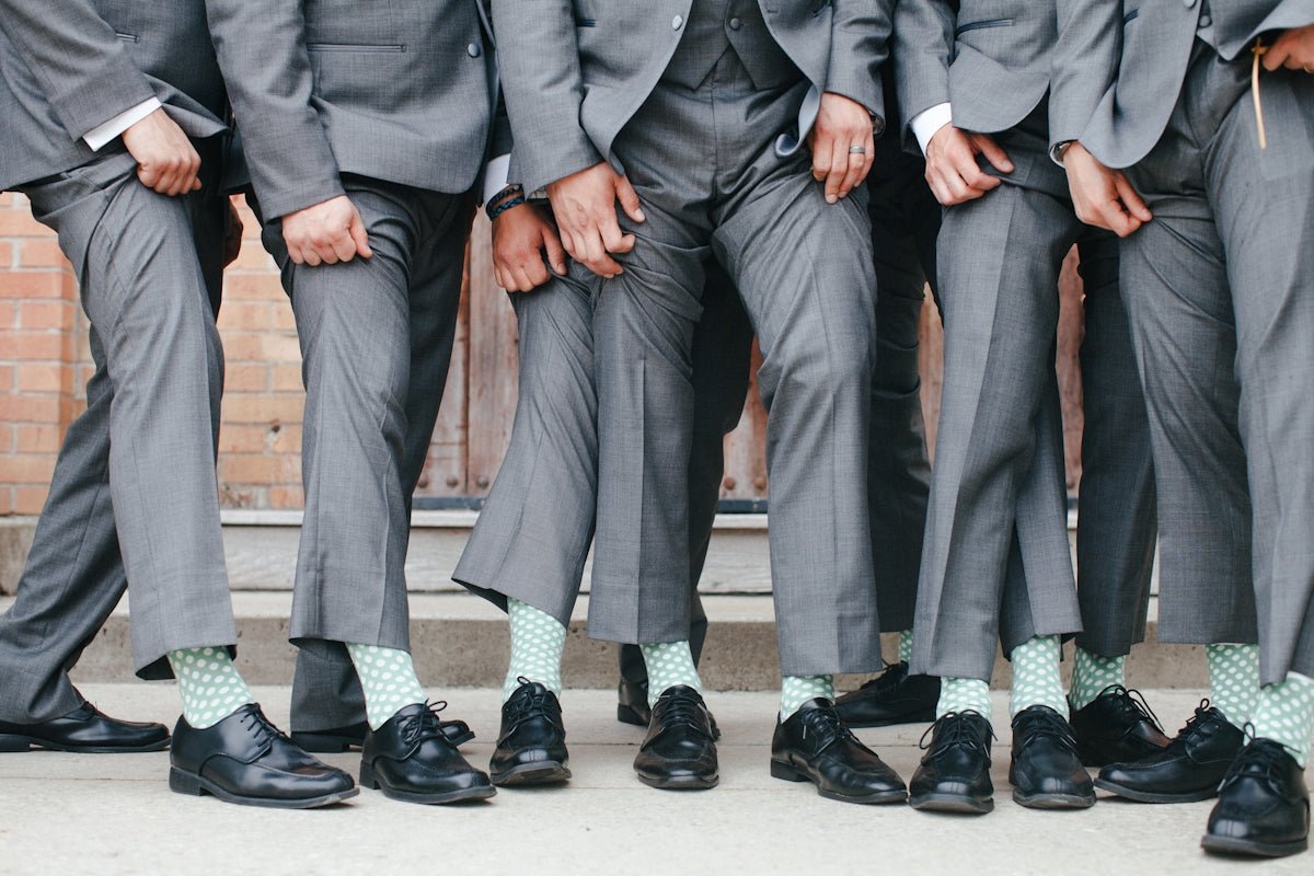 Group of men in grey suits and patterned socks