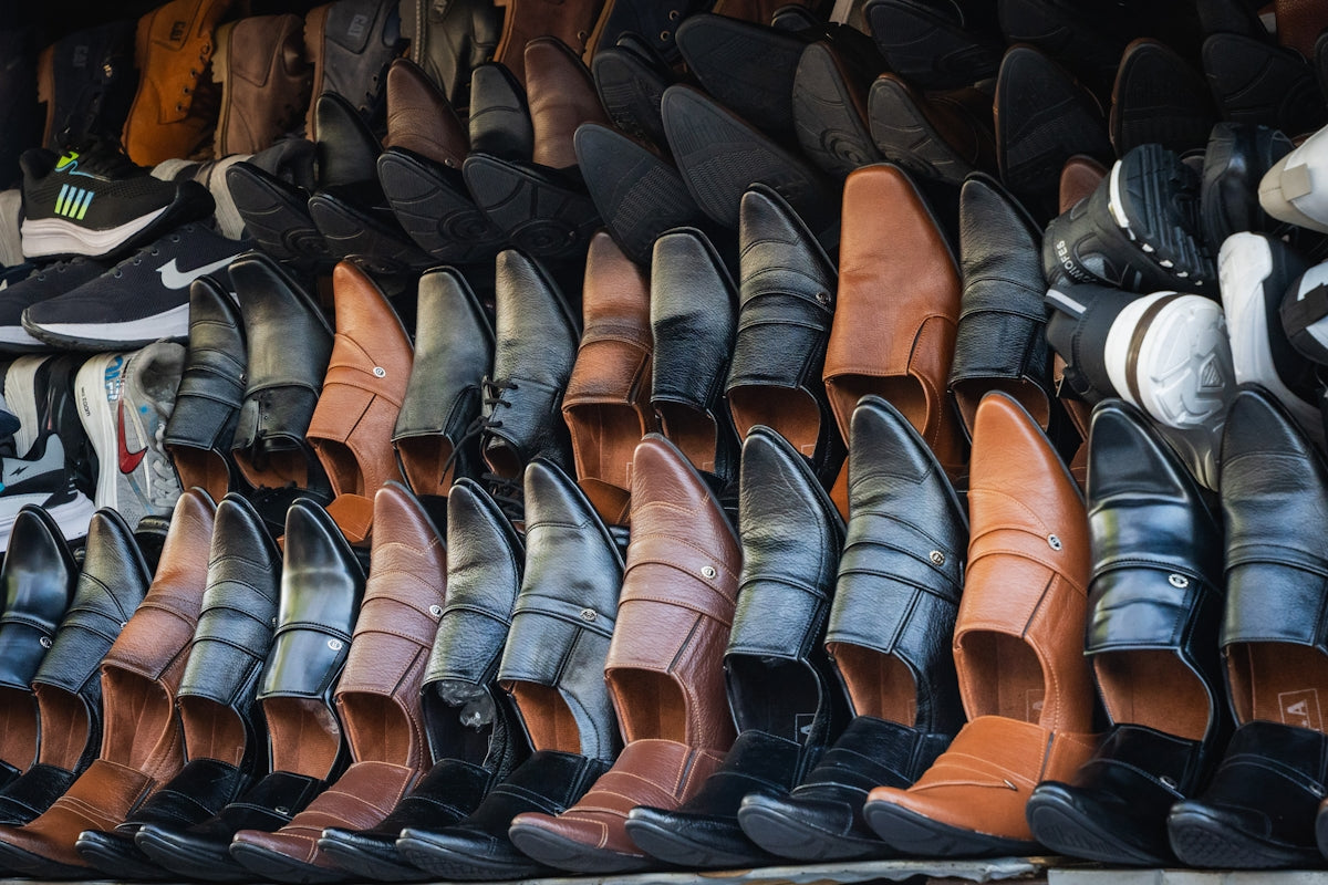 Rows of men's leather shoes displayed for sale.