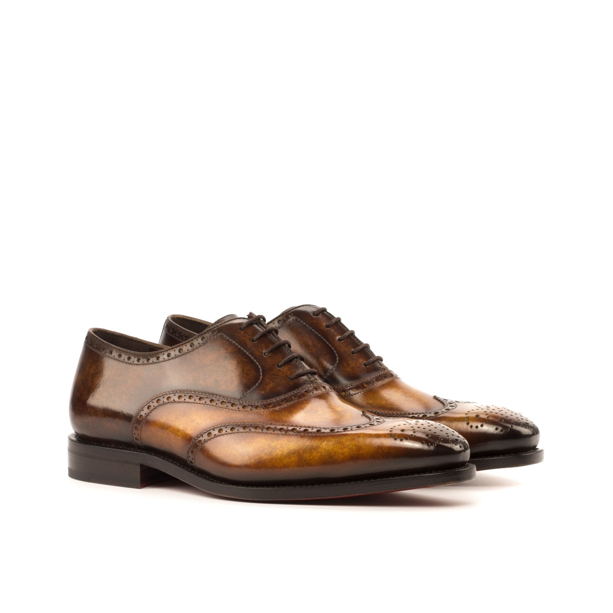 Pair of brown leather dress shoes on a white background