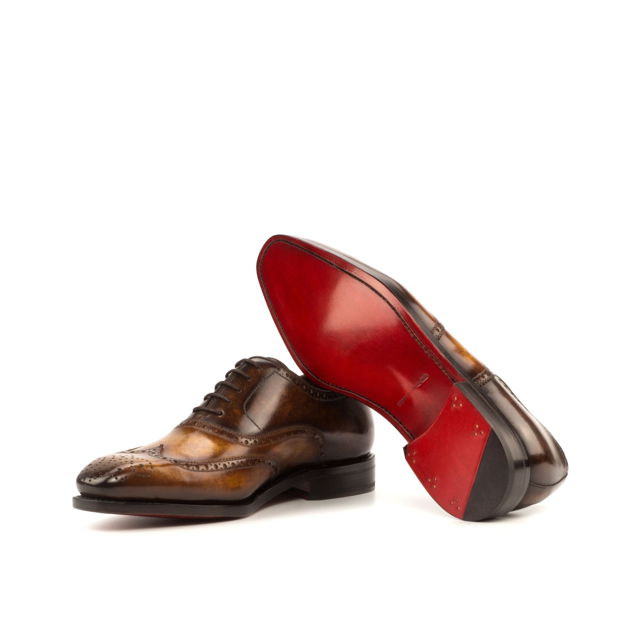 Brown leather dress shoes with a red sole on a white background