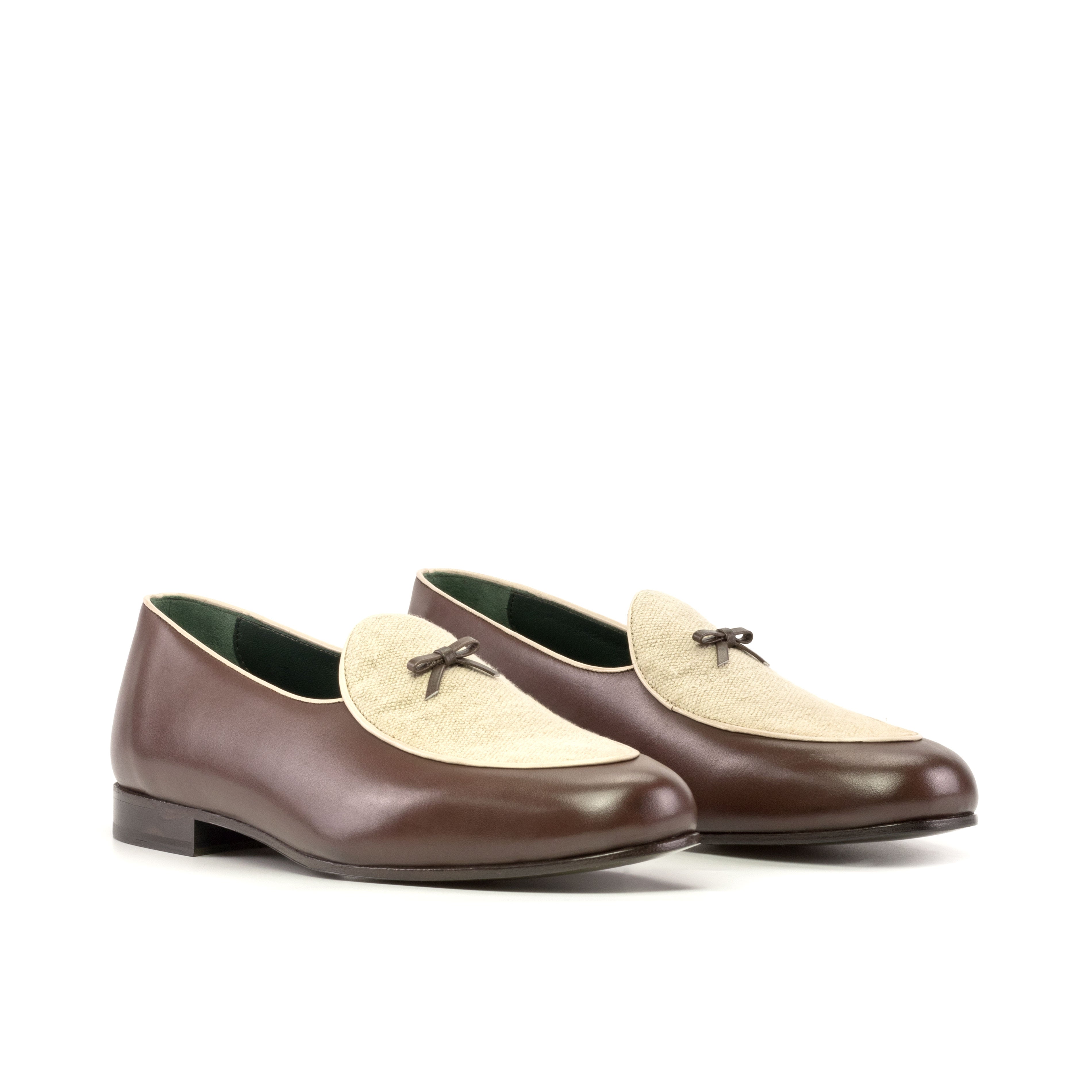 Pair of brown and beige loafers on a white background