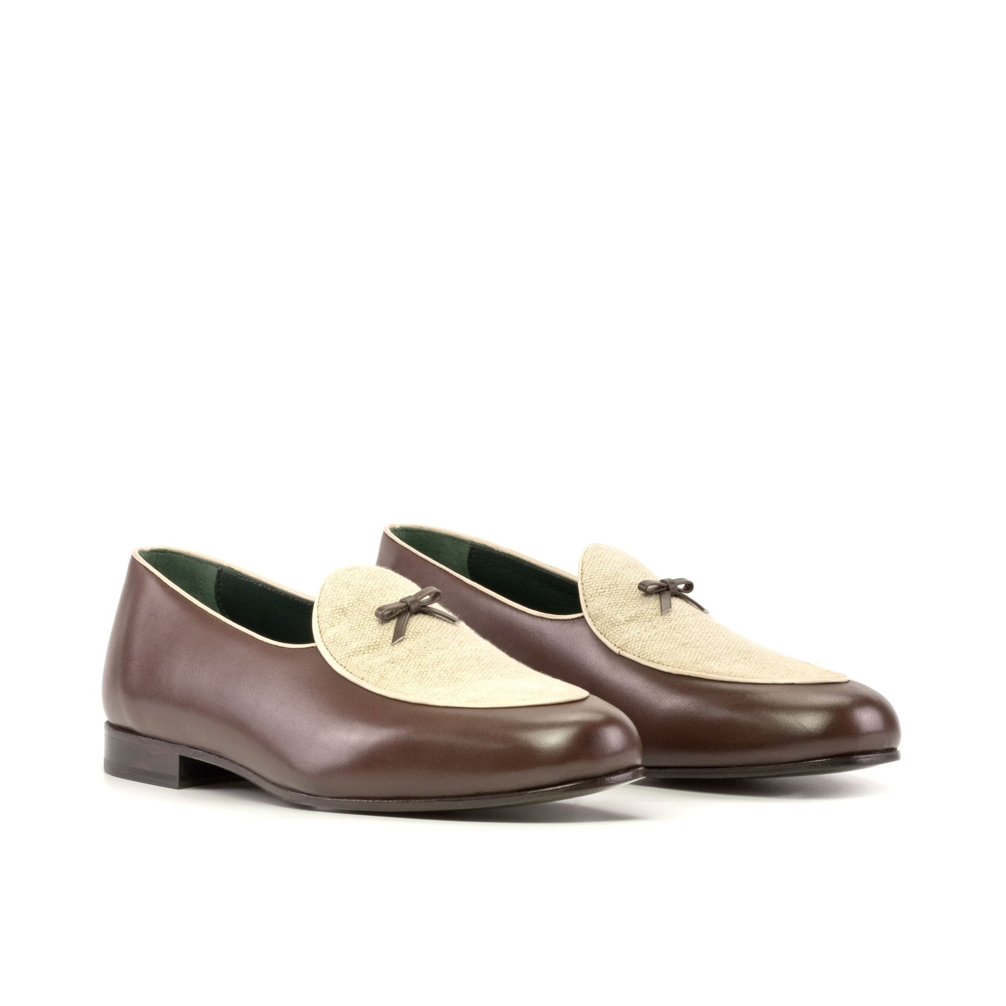 Pair of brown and beige loafers on a white background