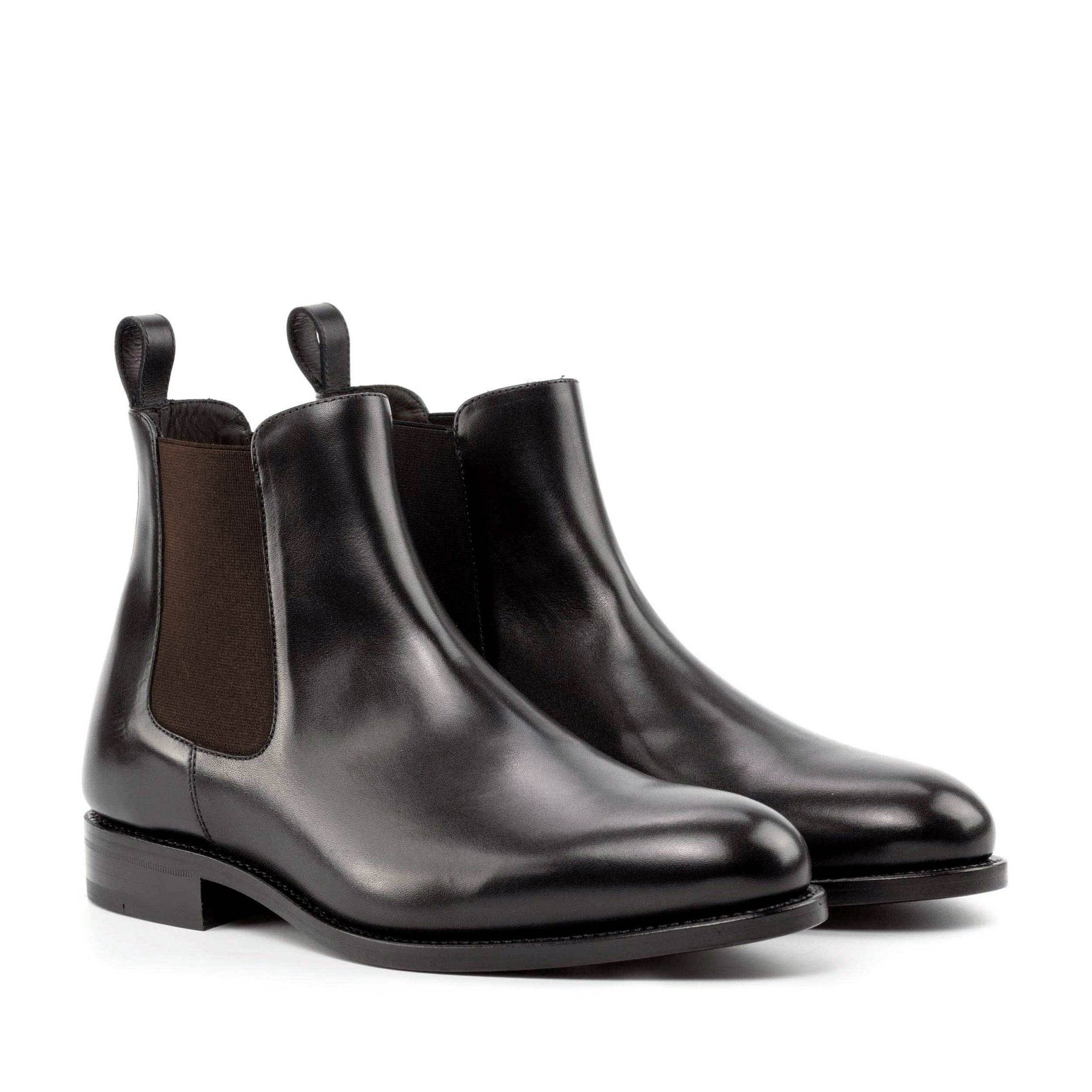 A pair of black genuine leather Chelsea boots for men with a rounded toe and side elastic panels.