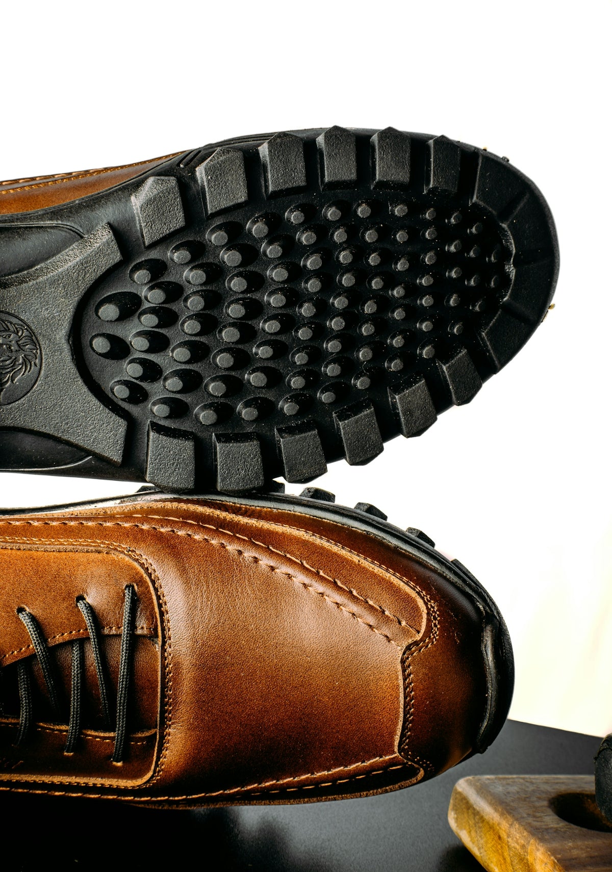 a pair of brown shoes sitting on top of a table
