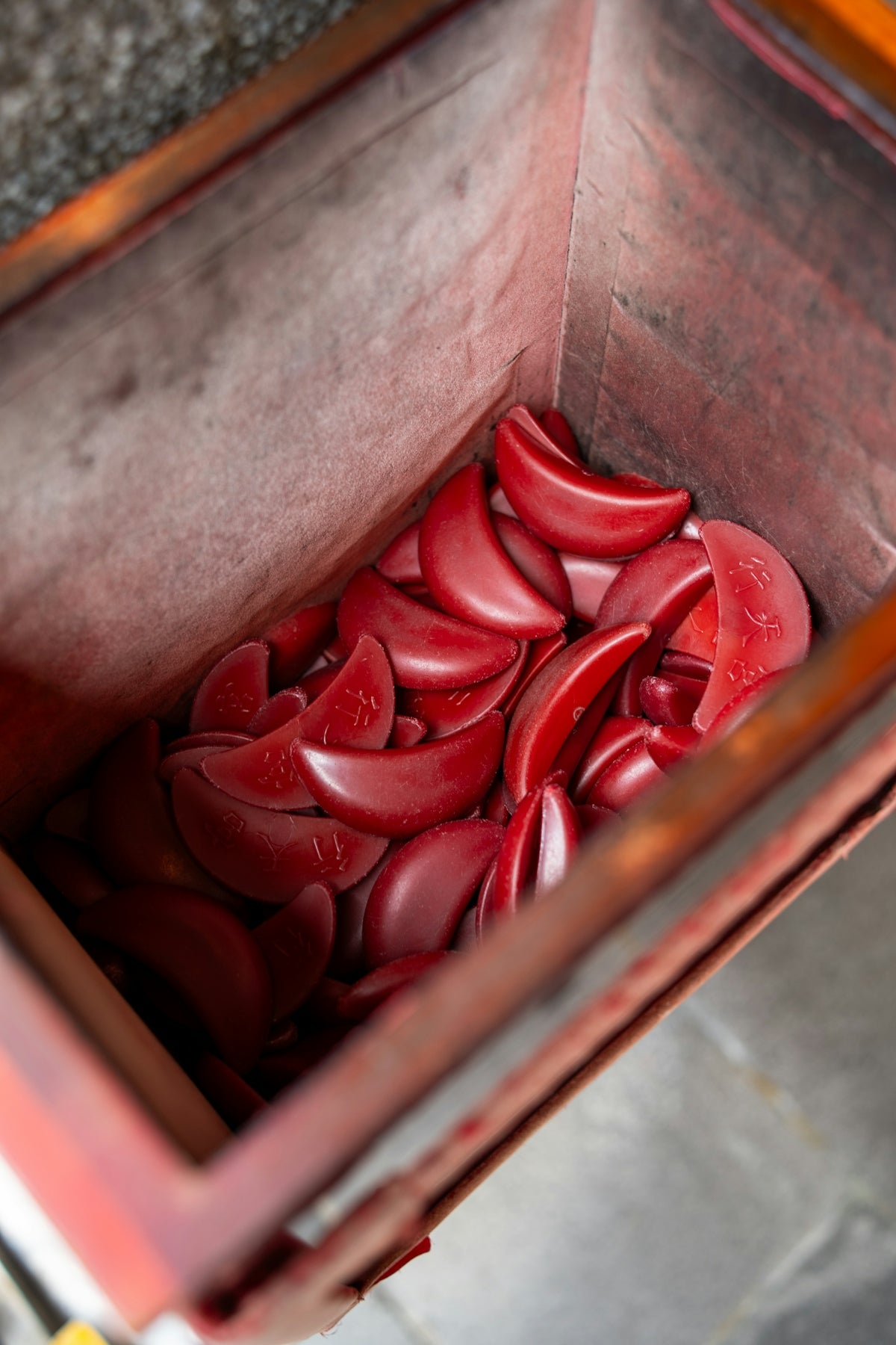 Red fortune telling blocks sit inside a container.