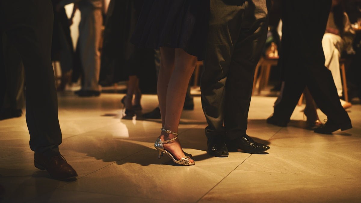 People dancing at a formal event with elegant shoes.