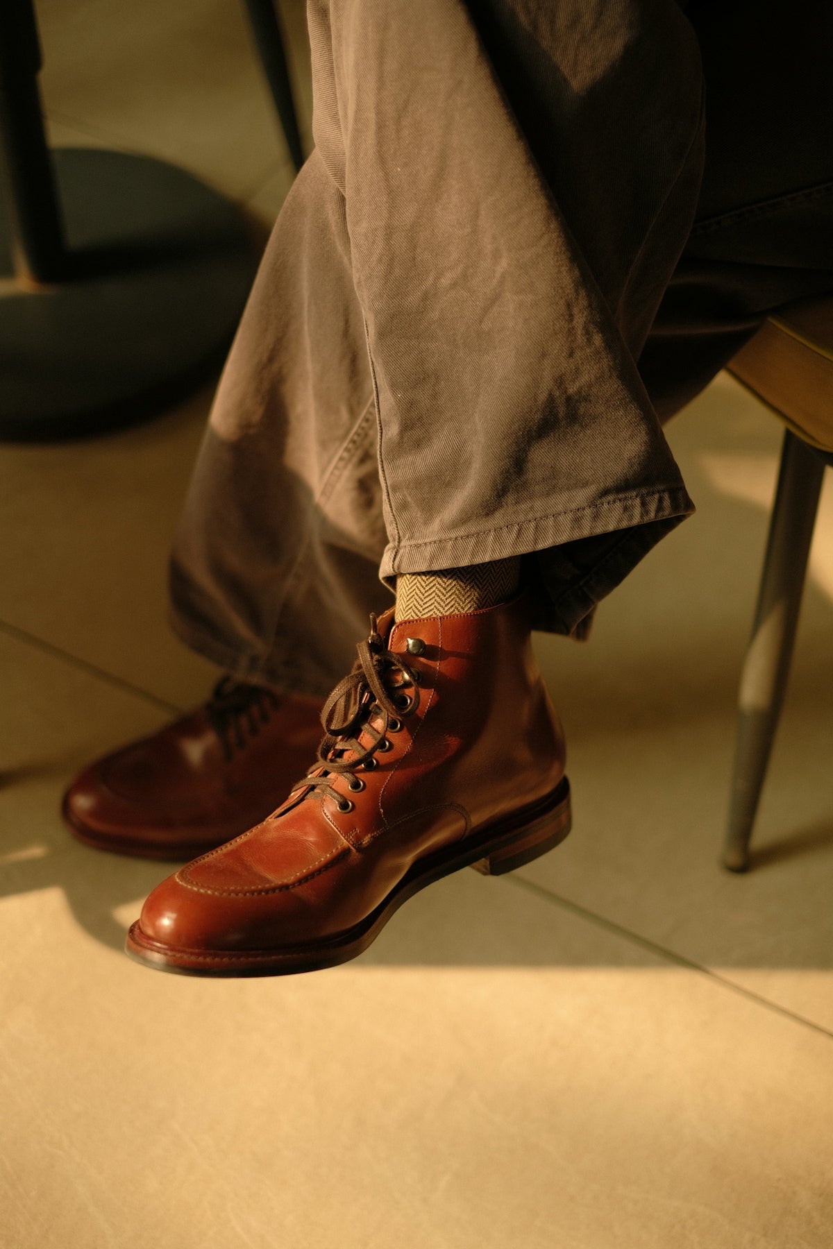 Person wearing brown leather boots and pants