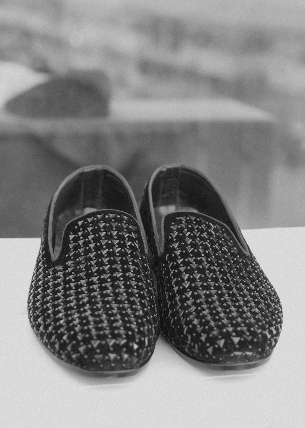 A pair of patterned slip-on shoes in black and white.
