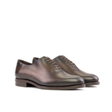 A pair of brown luxury leather oxford shoes with a rounded toe and leather sole.