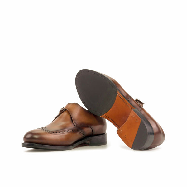 Brown leather shoes with a focus on the sole on a white background