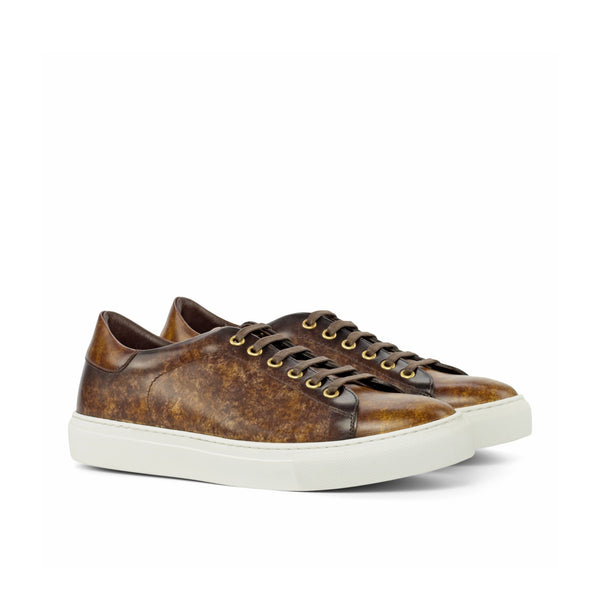 Brown leather sneaker with white sole on a white background