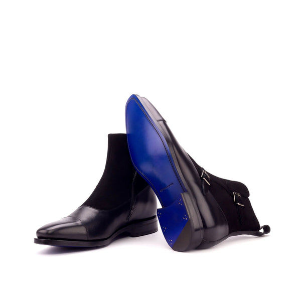 A pair of black men's leather and suede buckle boots with a monk strap and side zipper.