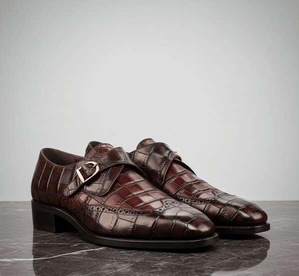 Pair of brown leather shoes with a decorative buckle on a gray surface.