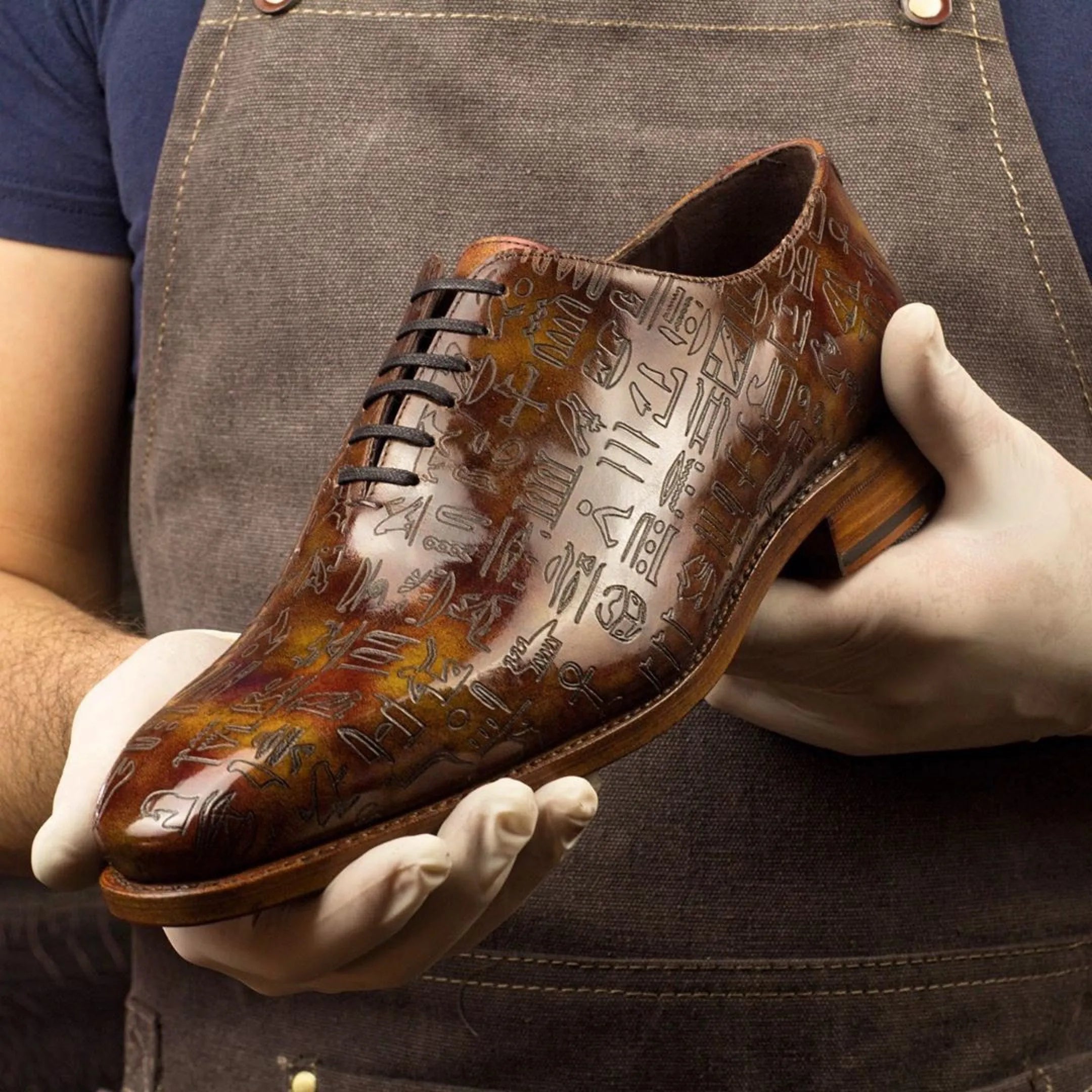 Brown leather dress shoe with hieroglyphic design, Egyptian Patina Wholecut in Italian crust leather