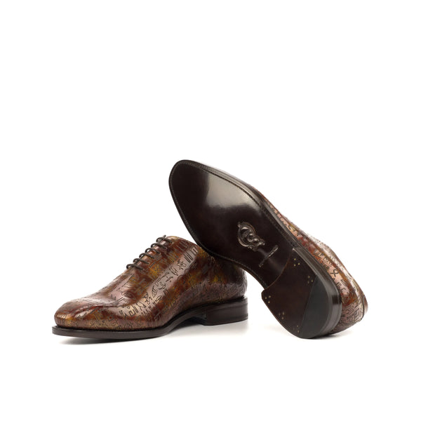 Brown patterned leather dress shoes, featuring Egyptian Patina Wholecut and soft chisel toe